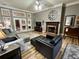 Comfortable living room featuring a fireplace, ceiling fan, and a neutral color palette at 5220 Wild Cedar Dr, Buford, GA 30518