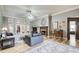 A cozy living room with a fireplace, wood floors, and neutral colors at 5220 Wild Cedar Dr, Buford, GA 30518