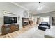 Cozy living room featuring a fireplace, TV, and comfortable seating, creating a welcoming atmosphere at 5220 Wild Cedar Dr, Buford, GA 30518