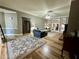 Open-concept living room with hardwood floors, fireplace, and stylish decor at 5220 Wild Cedar Dr, Buford, GA 30518