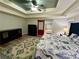 The main bedroom offers a decorative ceiling, attractive furniture, and access to the ensuite bath at 5220 Wild Cedar Dr, Buford, GA 30518