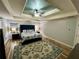 Bright main bedroom boasts a tray ceiling, stylish decor, and windows for natural light at 5220 Wild Cedar Dr, Buford, GA 30518