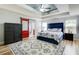 Spacious main bedroom with a tray ceiling, decorative rug, and access to the main bathroom at 5220 Wild Cedar Dr, Buford, GA 30518
