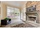 Bright sunroom with a stone fireplace, large windows, and decorative tiled floor at 5220 Wild Cedar Dr, Buford, GA 30518