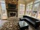Bright sunroom with stone fireplace, tile floors, and ample windows at 5220 Wild Cedar Dr, Buford, GA 30518