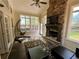 Bright sunroom with stone fireplace, tile floors, and ample windows at 5220 Wild Cedar Dr, Buford, GA 30518