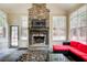 The sunroom features a stone fireplace, bright windows, and a slate tile floor at 5220 Wild Cedar Dr, Buford, GA 30518