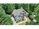 Aerial view of the home shows the well-manicured landscaping and mature trees on the property at 7920 Tintern Trce, Duluth, GA 30097