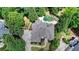 A high-angle view of the home, showcasing its expansive driveway and private backyard oasis at 7920 Tintern Trce, Duluth, GA 30097