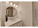 Bathroom vanity featuring white cabinets, an octagonal mirror, and modern fixtures at 7920 Tintern Trce, Duluth, GA 30097