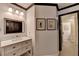 Bathroom vanity with white drawers and wall decor that leads to another bathroom at 7920 Tintern Trce, Duluth, GA 30097