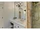 Bright bathroom featuring a tiled shower, vanity with marble countertops, tile flooring and a decorative light fixture at 7920 Tintern Trce, Duluth, GA 30097