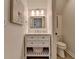 Powder room with a modern vanity and a mirror illuminated by a three light vanity fixture at 7920 Tintern Trce, Duluth, GA 30097