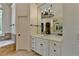 Bright bathroom features a bathtub, vanity with marble countertops, decorative light fixture, and tile flooring at 7920 Tintern Trce, Duluth, GA 30097