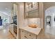 Hall butler's pantry featuring tiled backsplash, beverage center and storage at 7920 Tintern Trce, Duluth, GA 30097