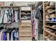 Walk-in closet with custom shelving, multiple hanging rods, drawers, and shoe storage at 7920 Tintern Trce, Duluth, GA 30097