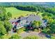 Stunning aerial view of the clubhouse overlooking a lush green golf course and parking area at 7920 Tintern Trce, Duluth, GA 30097