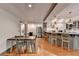 Inviting dining area featuring a kitchen bar, stainless steel refrigerator, and modern lighting at 7920 Tintern Trce, Duluth, GA 30097
