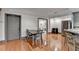 Inviting dining area featuring a kitchen bar, stainless steel refrigerator, and hardwood flooring at 7920 Tintern Trce, Duluth, GA 30097