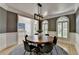 Dining room featuring natural lighting, neutral colored walls, and an ornate chandelier at 7920 Tintern Trce, Duluth, GA 30097