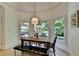 Dining room features a wood table with bench seating and large windows at 7920 Tintern Trce, Duluth, GA 30097