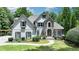 Charming two-story home with stone accents, manicured lawn, and inviting entryway at 7920 Tintern Trce, Duluth, GA 30097