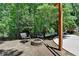 Relaxing outdoor space with a stone firepit, comfortable seating, and mature landscaping at 7920 Tintern Trce, Duluth, GA 30097