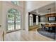 Spacious foyer with arched doorway, light hardwood floors, and dining area at 7920 Tintern Trce, Duluth, GA 30097