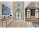 Bright foyer features a soaring ceiling, arched doorway, and light hardwood floors at 7920 Tintern Trce, Duluth, GA 30097