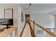 Upstairs hallway with hardwood floors and a view of the foyer below at 7920 Tintern Trce, Duluth, GA 30097