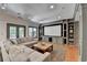Cozy home theater with large screen, comfortable seating, and built-in shelving at 7920 Tintern Trce, Duluth, GA 30097