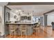 Stylish kitchen bar area with seating, modern appliances, and white brick accent wall at 7920 Tintern Trce, Duluth, GA 30097