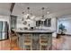 Stylish kitchen bar area with pendant lights, seating, and modern appliances at 7920 Tintern Trce, Duluth, GA 30097