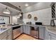 Modern kitchen counter area with stainless steel appliances and white brick accent wall at 7920 Tintern Trce, Duluth, GA 30097