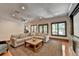 Relaxing living room featuring a comfortable sectional sofa, projector, and hardwood flooring at 7920 Tintern Trce, Duluth, GA 30097