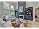 Spacious living room with large windows, fireplace, built-ins, and hardwood floors at 7920 Tintern Trce, Duluth, GA 30097