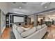 Open concept living room with hardwood floors, built in entertainment center, and a wet bar at 7920 Tintern Trce, Duluth, GA 30097