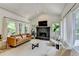 Cozy living room with a stone fireplace and lots of natural light at 7920 Tintern Trce, Duluth, GA 30097