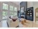 Elegant living room boasts natural light, fireplace, and custom built-ins at 7920 Tintern Trce, Duluth, GA 30097