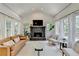Inviting living room features a stone fireplace and large windows with natural light at 7920 Tintern Trce, Duluth, GA 30097