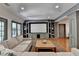 Spacious living room with hardwood floors, built-in entertainment center, and neutral paint at 7920 Tintern Trce, Duluth, GA 30097