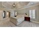 Spacious main bedroom featuring a tray ceiling, modern lighting, and plenty of natural light at 7920 Tintern Trce, Duluth, GA 30097