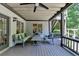 Covered patio with ceiling fan, comfortable seating, and wooden flooring offers a relaxing outdoor space at 7920 Tintern Trce, Duluth, GA 30097