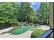 Beautiful pool with waterfall and spa, surrounded by lush greenery and mature trees at 7920 Tintern Trce, Duluth, GA 30097