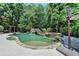 Resort-style pool and spa offer a relaxing outdoor oasis with mature trees and a waterfall feature at 7920 Tintern Trce, Duluth, GA 30097