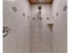 Shower stall featuring neutral tile, a shower head, and a built in shelf at 7920 Tintern Trce, Duluth, GA 30097