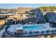 Beautiful backyard with a pool, hot tub, covered patio, and ample seating for entertaining at 149 Avalon Way, Sharpsburg, GA 30277