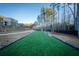Spacious backyard featuring artificial turf and mature trees, perfect for outdoor activities at 149 Avalon Way, Sharpsburg, GA 30277