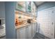 Stylish wet bar area features granite countertops, glass cabinets, and wine storage at 149 Avalon Way, Sharpsburg, GA 30277