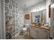 Stylish powder room featuring decorative wall, marble countertop, and ample storage space at 149 Avalon Way, Sharpsburg, GA 30277